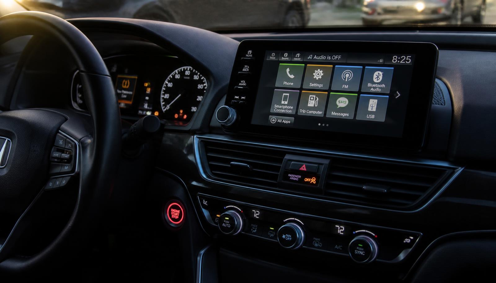 Modern car dashboard with a large infotainment touchscreen and illuminated warning indicators